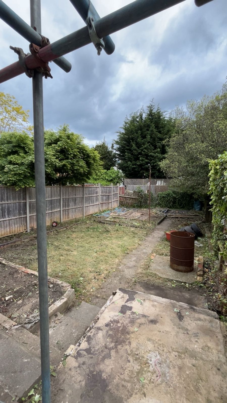 Scaffolding erected over a cleared rear plot ready for demolition works